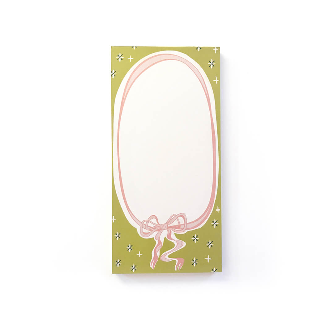 A 3.8x7.8" notepad with a pink bow and green background.