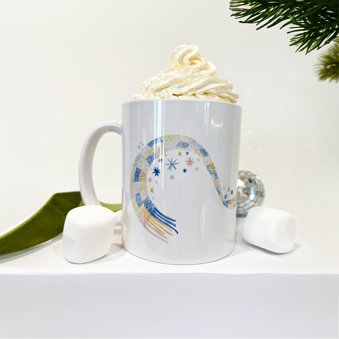 Ceramic mug product shot with whipped cream and marshmallows.