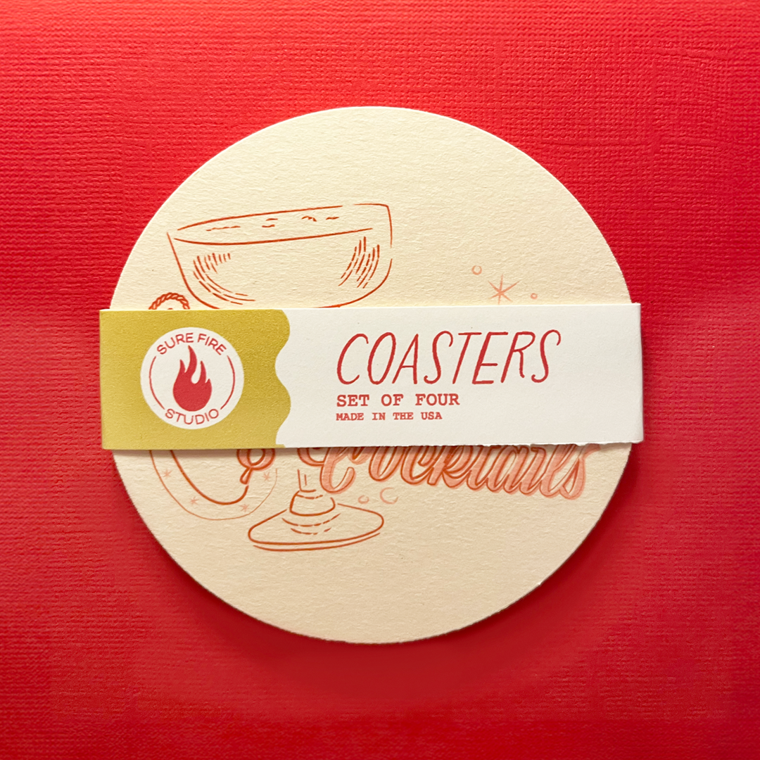 Pulpboard coaster that reads "Cowgirls & Cocktails" in a rope and script font with horseshoes and cocktails glasses.